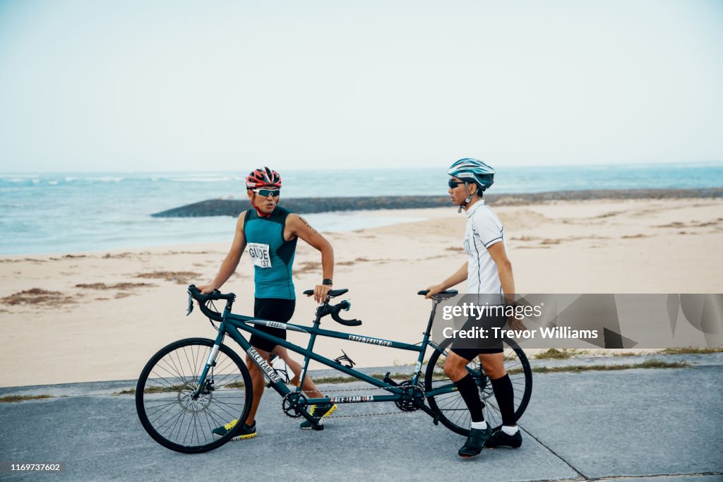 Blind triathlete and his guide training on their tandem bicycle