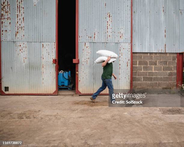 farmer carrying farming bags - british culture walking stock pictures, royalty-free photos & images