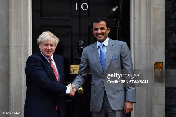 Britain's Prime Minister Boris Johnson greets the emir of Qatar Sheikh Tamim bin Hamad al-Thani in Downing street prior to their meeting in central...