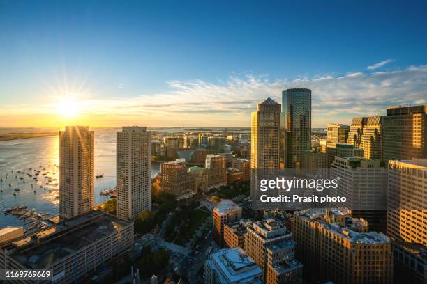 aerial view of boston harbor and financial district at sunset in boston, massachusetts, usa. - boston massachusetts bildbanksfoton och bilder