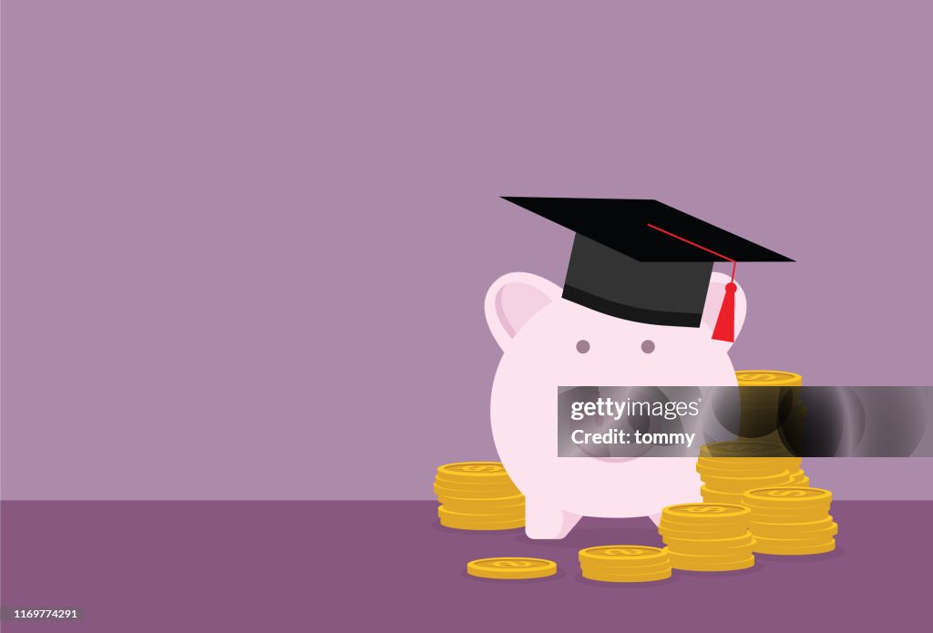 Piggy bank with a graduation cap and stack of coin