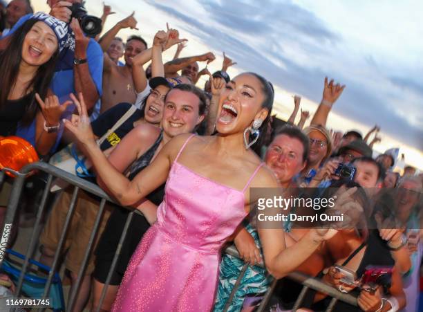 Meaghan Rath poses for a photo with fans before the Sunset On The Beach event celebrating the 10th season of "Hawaii Five-0" and season 2 of "Magnum...