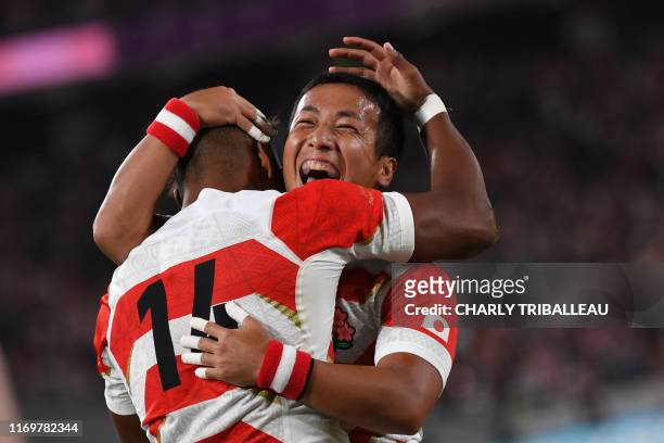 Japan's wing Kotaro Matsushima is congratulated after scoring a try during the Japan 2019 Rugby World Cup Pool A match between Japan and Russia at...