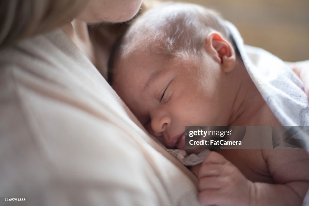 新生児は母親の胸の上で眠る