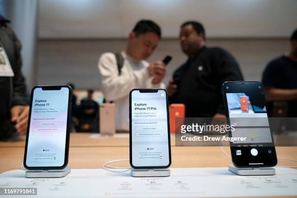 IPhone 11 and iPhone 11 Pro models are displayed as customers shop at Apple's flagship 5th Avenue store on September 20, 2019 in New York City....