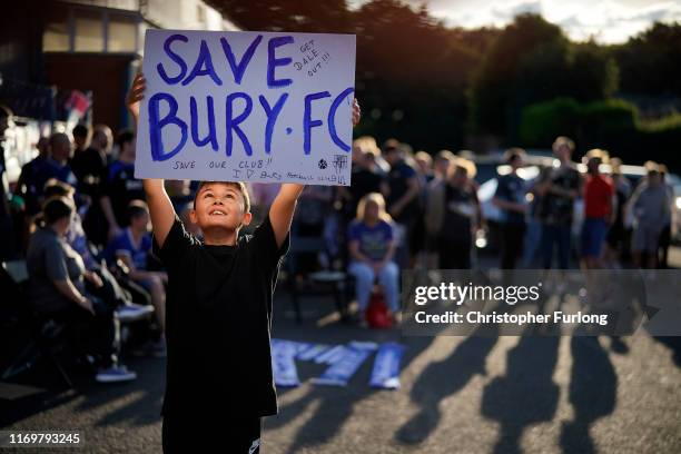 Fans chant songs as they stand outside Bury Football Club awaiting a rescue plan for the ill-fated club on August 23, 2019 in Bury, England. Bury...