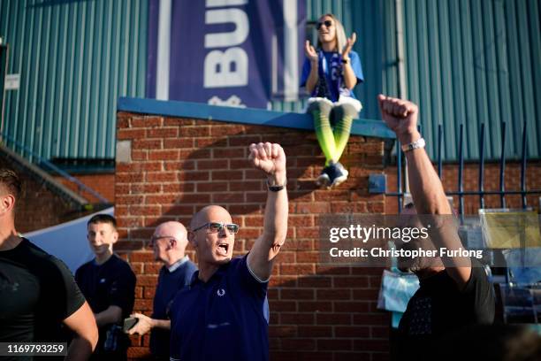 Fans chant songs as they stand outside Bury Football Club awaiting a rescue plan for the ill-fated club on August 23, 2019 in Bury, England. Bury...