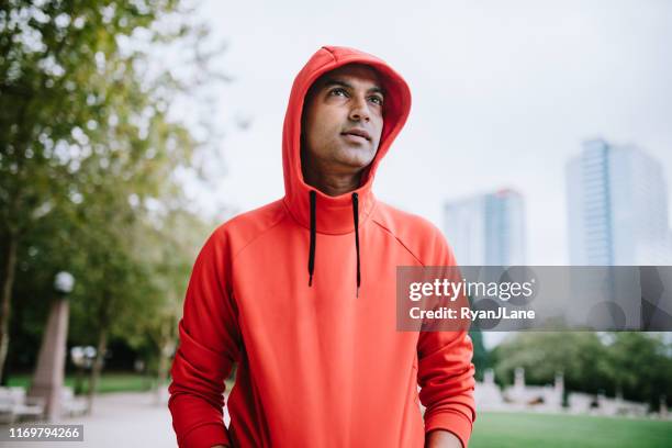 athlete running in bellevue city park - hoodie stock pictures, royalty-free photos & images