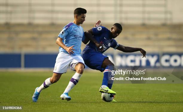 Marc Guehi of Chelsea FC battles with Nabil Touaizi of Manchester City during the Premier League 2 match between Manchester City and Chelsea at...