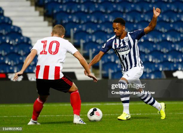 Chris Willock of West Bromwich Albion is challenged by Jake Hackett of Sunferland AFC during the Premier League 2 match between West Bromwich Albion...