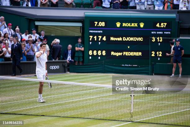 Novak Djokovic of Serbia in front of the scoreboard after defeating Roger Federer of Switzerland during the Men's Singles Final at The Wimbledon Lawn...