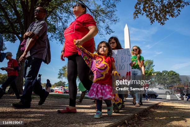 Mothers and their children with Moms Clean Air Force walk to meet up with other protesters for the Global Climate Strike protests on September 20,...
