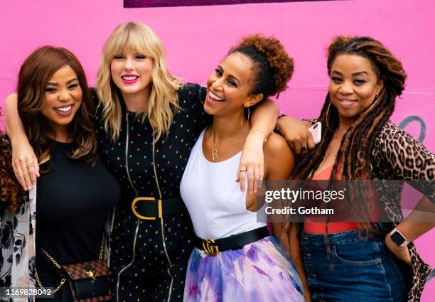 Eliotte Nicole, Taylor Swift, Melanie Nyema and Kamilah Marshall pose in front of a mural introducing Taylor Swift's latest album "Lover" on August...