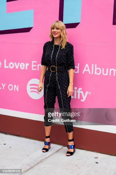 Taylor Swift poses in front of a mural introducing her latest album "Lover" on August 23, 2019 in in the Brooklyn borough of New York City.