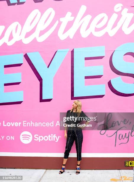 Taylor Swift poses in front of a mural introducing her latest album "Lover" on August 23, 2019 in in the Brooklyn borough of New York City.