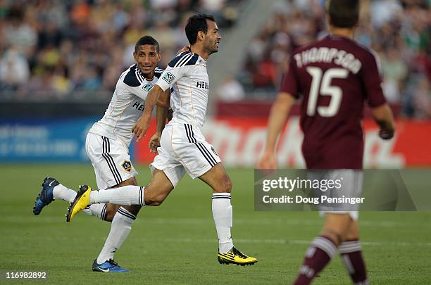 Juninho of the Los Angeles Galaxy celebrates his goal in the 42nd minute with teammate Sean Franklin of the Galaxy as Wells Thompson of the Colorado...