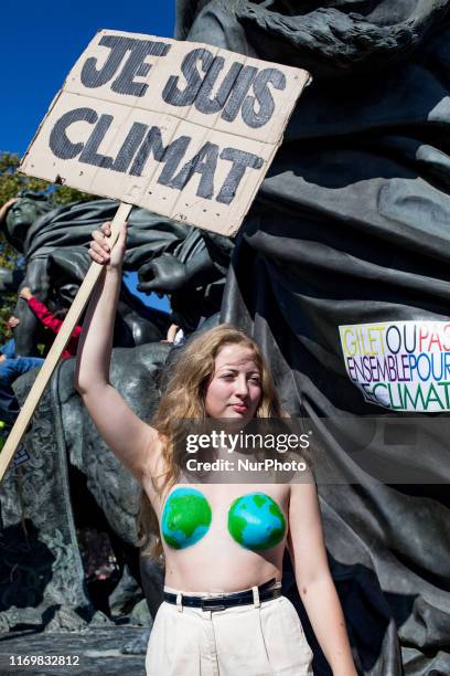 Paris, France, 20 September 2019. A young woman poses shirtless with a sign &quot;I am climate&quot; to defend the planet and against climate change....