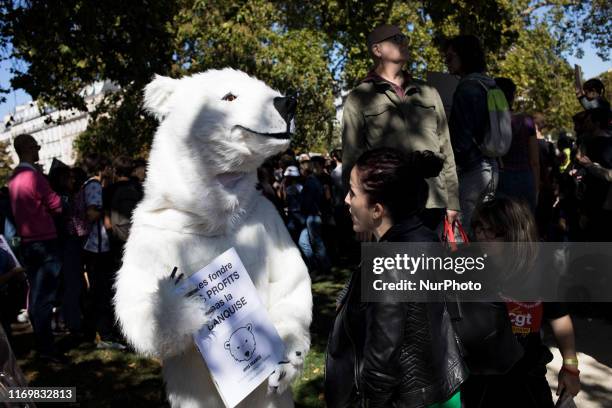Paris, France, 20 September 2019. A person disguised as a polar bear talks with journalists to defend the planet and against climate change as part...