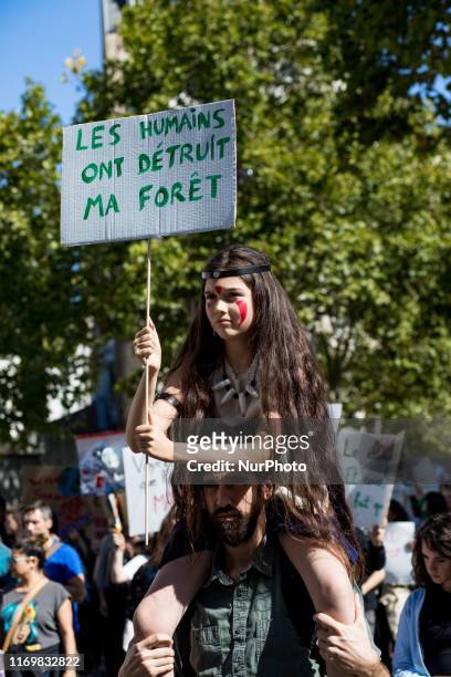 Paris, France, 20 September 2019. A young girl dressed as an Indian woman marches on her father's shoulders to defend the planet and against climate...