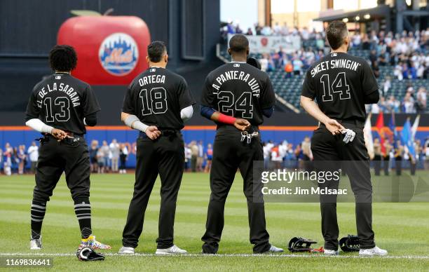 Ronald Acuna Jr. #13, Rafael Ortega, Adeiny Hechavarria and Matt Joyce of the Atlanta Braves stand during the national anthem prior to a game against...