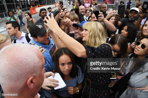 Taylor Swift poses with fans at the Spotify Mural on Album Release Day at Kent Avenue and South 1st Street, Williamsburg, on August 23, 2019 in...