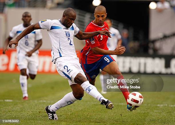 Alvaro Saborio of Costa Rica and Osman Chavez of Honduras battle for possession during the 2011 Gold Cup Quarterfinals on June 18, 2011 at the New...