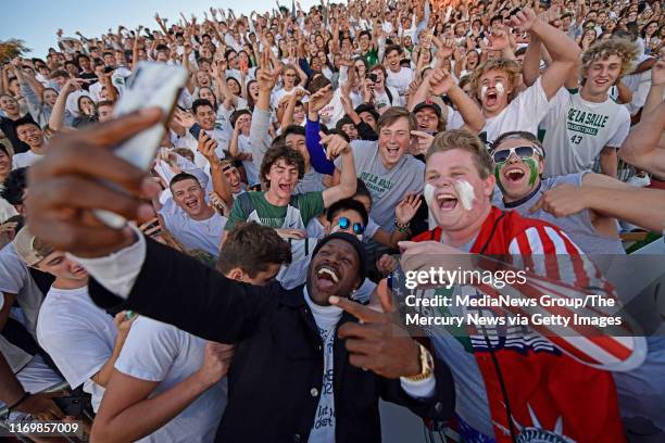Oakland Raiders Antonio Brown makes a surprise appearance and takes a selfie with the De La Salle student body during the second quarter of their...