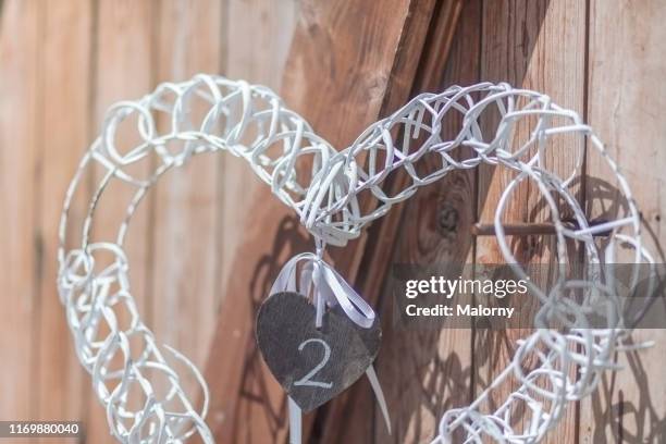 decorative heart in front of a wooden barn door. wedding. - second wedding anniversary stock pictures, royalty-free photos & images