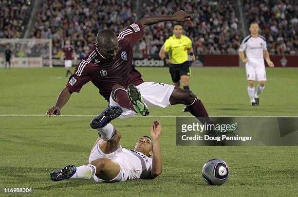 Sean Franklin of the Los Angeles Galaxy kicks the ball away from Omar Cummings of the Colorado Rapids at Dick's Sporting Goods Park on June 18, 2011...