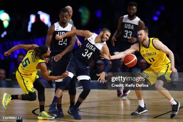 Patty Mills of the Boomers and Nicholas Kay of the Boomers steal the ball from Jayson Tatum of the USA during game two of the International...