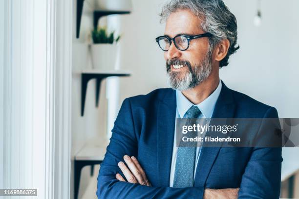 confident and smiling businessman - corporate business owner stock pictures, royalty-free photos & images