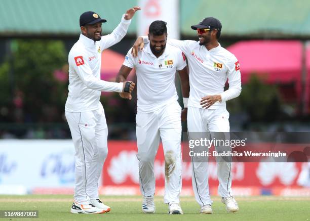 Dimuth Karunaratne of Sri Lanka celebrates with his team mates Lahiru Thirimanne and Dilruwan after the dismissal of Kane Williamson of New Zealand...