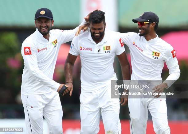 Dimuth Karunaratne of Sri Lanka celebrates with his team mates Lahiru Thirimanne and Dilruwan after the dismissal of Kane Williamson of New Zealand...