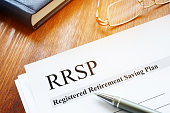 RRSP Registered Retirement Saving Plan documents on table.