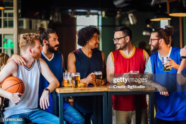 appassionati di basket al pub che discutono del campionato - uniforme di basket foto e immagini stock