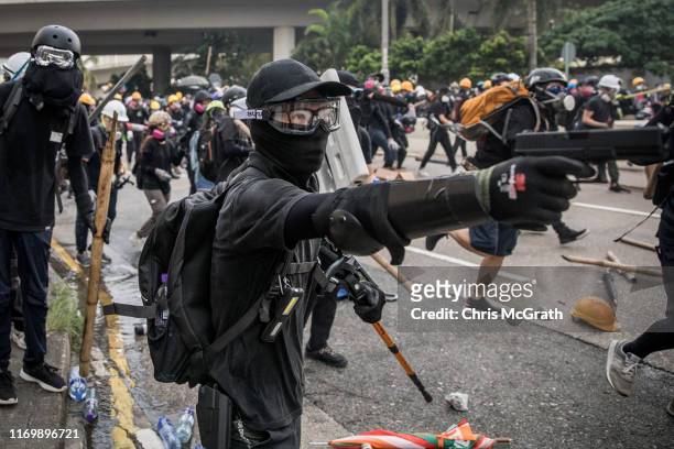 Protester fires a BB gun during clashes with police after a rally in Kwun Tong on August 24, 2019 in Hong Kong, China. Pro-democracy protesters have...