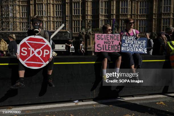 Protester wearing a gas mask holds a STOP sign during the demonstration. Adult and youth walking out of work and schools to demand for an end to the...