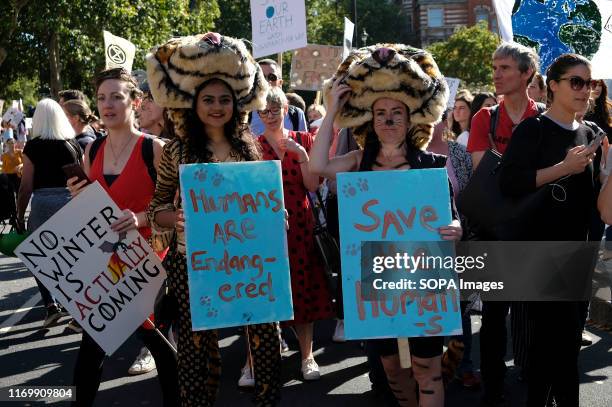 Protester wearing tiger costumes hold placards during the demonstration. Adult and youth walking out of work and schools to demand for an end to the...