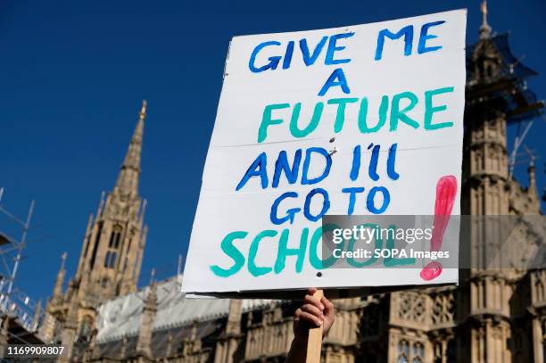 Protester holds a placard during the demonstration. Adult and youth walking out of work and schools to demand for an end to the use of fossil fuels...