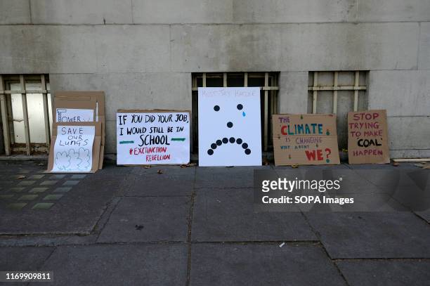 Climate change placards lie on the pavement during the protest in London. Adult and youth walking out of work and schools to demand for an end to the...