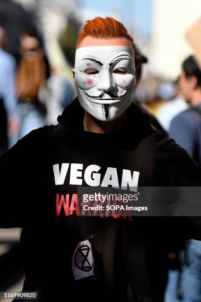 Vegan protester wearing an Anonymous mask joined the Climate strike protest in London. Adult and youth walking out of work and schools to demand for...