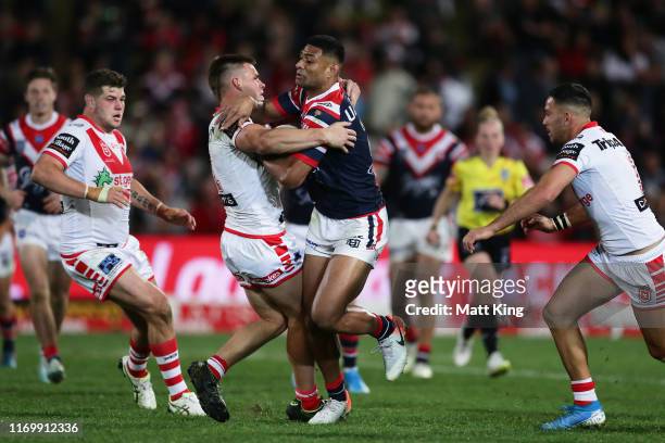 Daniel Tupou of the Roosters is tackled during the round 23 NRL match between the St George Illawarra Dragons and the Sydney Roosters at Jubilee...