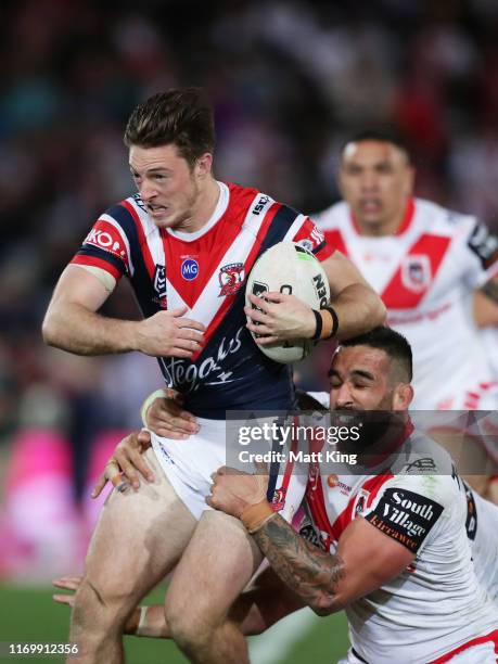 Sam Verrills of the Roosters is tackled by Paul Vaughan of the Dragons during the round 23 NRL match between the St George Illawarra Dragons and the...