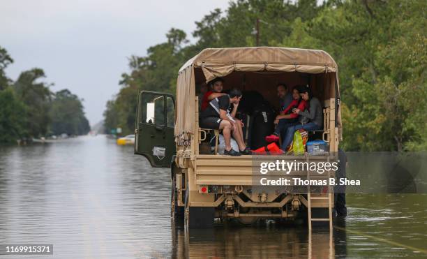 Evacuees sit in the back of a rescue truck on highway 124 on September 20, 2019 in Beaumont, Texas. Gov. Greg Abbott has declared much of Southeast...