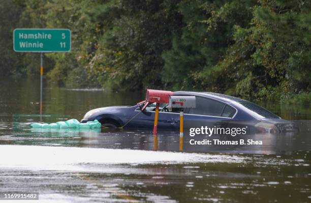 Car sits in the flooded waters on highway 124 on September 20, 2019 in Beaumont, Texas. Gov. Greg Abbott has declared much of Southeast Texas...