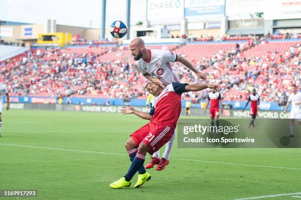 Toronto FC defender Laurent Ciman heads the ball over FC Dallas midfielder Michael Barrios during the MLS soccer game between FC Dallas and Toronto...