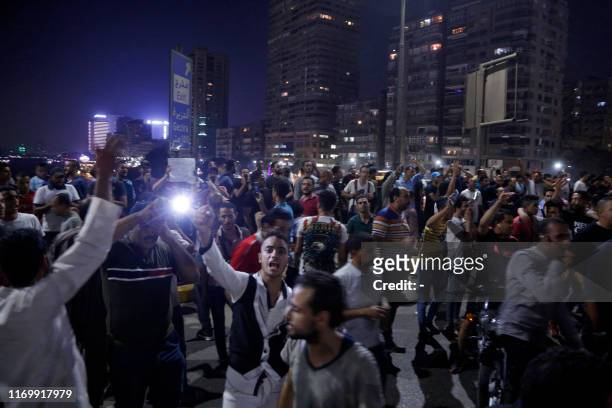 Protesters shout slogans as they take part in a protest calling for the removal of President Abdel Fattah al-Sisi, along the October 6 bridge linking...
