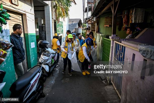 Volunteers pick up trash, such as plastics and cigarrette butts, during world cleanup day campaign in Jakarta, on September 21 in order to educate...