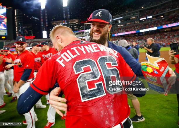 Dallas Keuchel of the Atlanta Braves dunks Mike Foltynewicz of the Atlanta Braves with milk at the conclusion of an MLB game against the San...