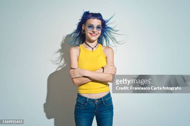 portrait of smiling young girl - colored sunglasses stockfoto's en -beelden